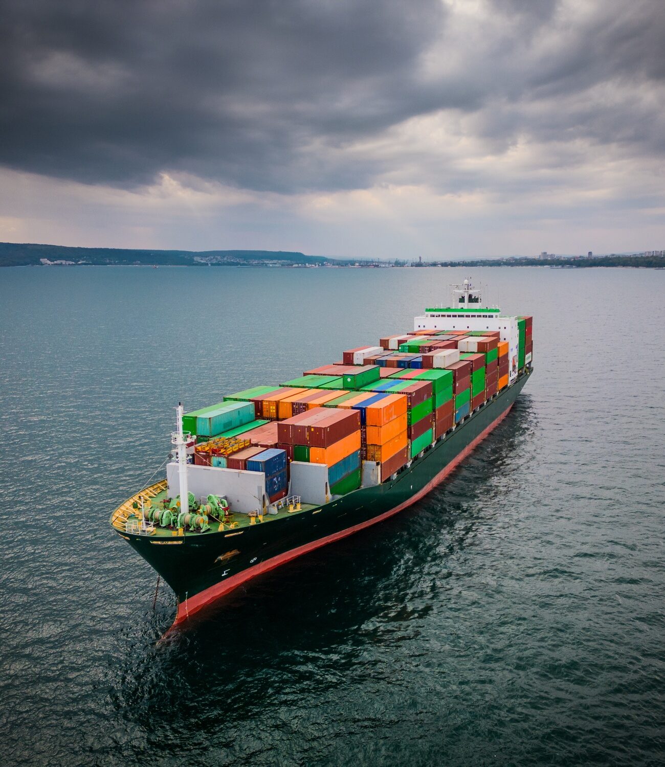A loaded container ship in the sea, aerial view, concept of international trade and shipping