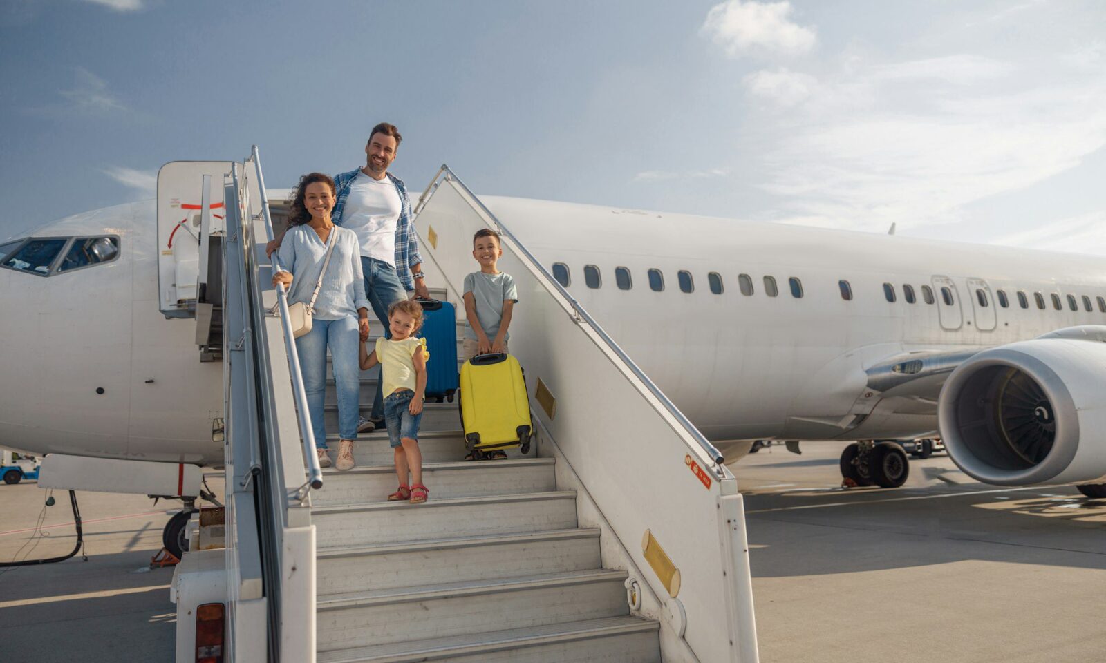 happy-family-of-four-getting-off-the-plane-on-a-daytime