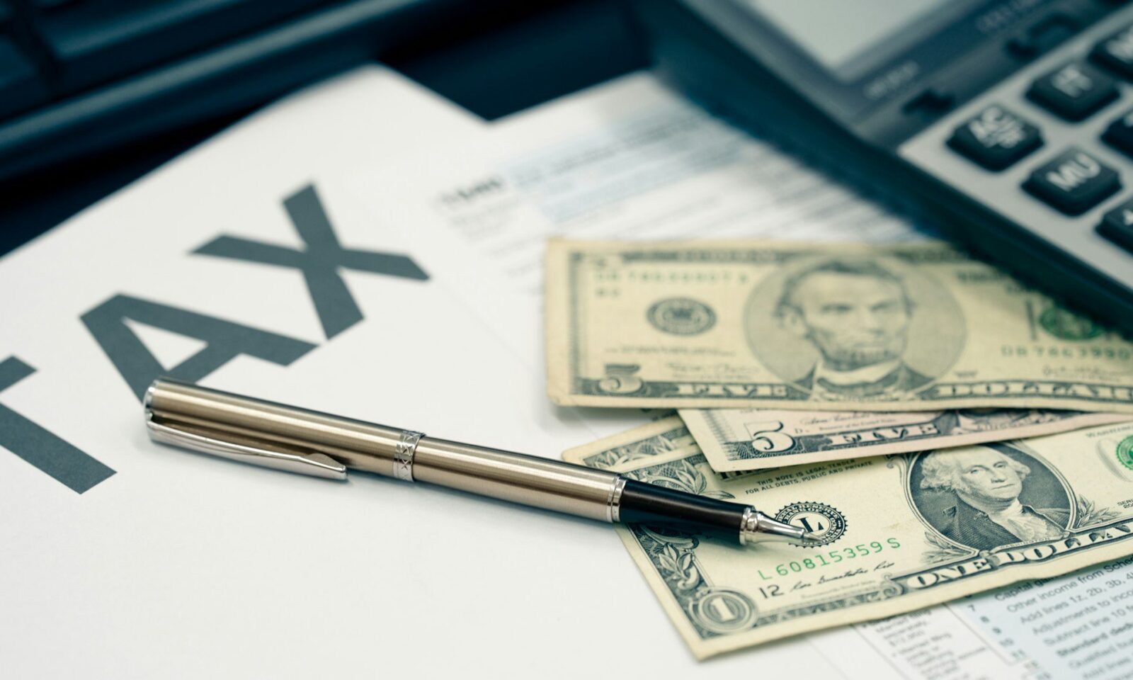 tax-season-concept-tax-planning-and-consulting-service-business-pen-calculator-dollar-banknote