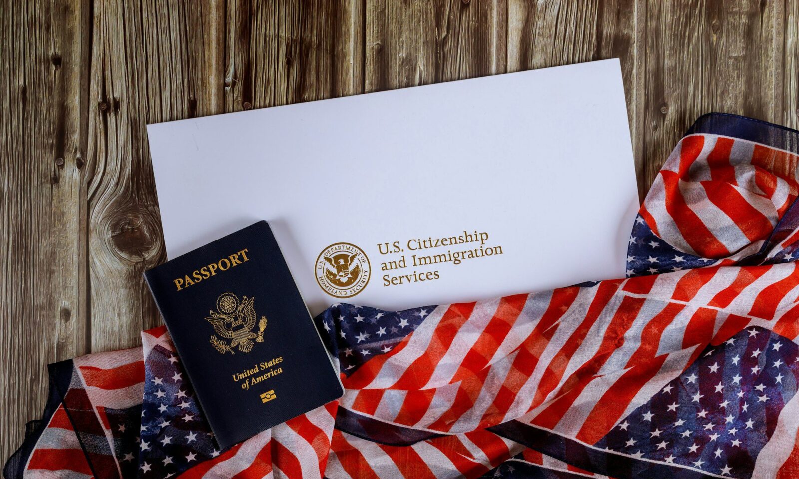 usa-passport-and-citizenship-naturalization-certificate-of-us-flag-over-wooden-background
