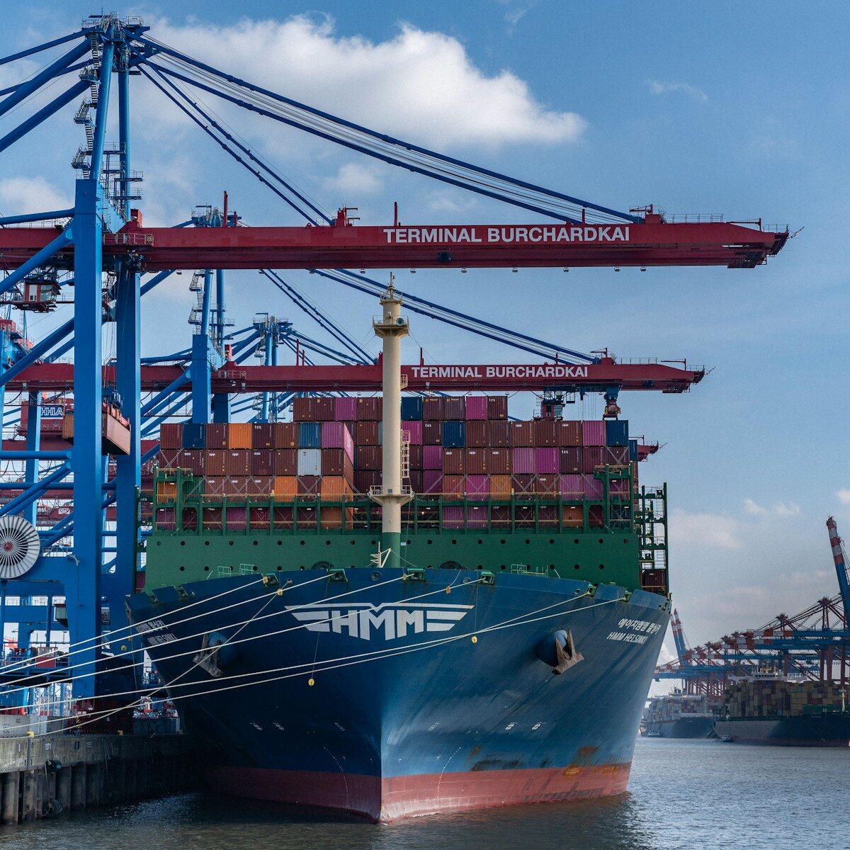 A container ship is docked at the harbor.